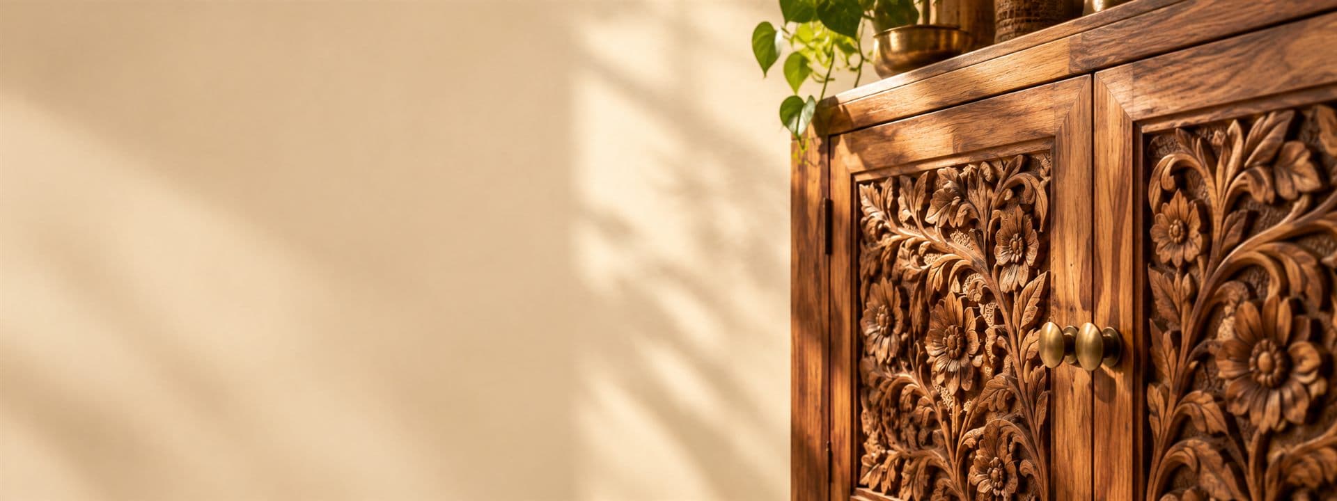 A hand-carved solid wood cabinet in raking light